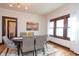 Elegant dining room with stylish furnishings, a modern light fixture, and large windows at 625 Dequincy St, Indianapolis, IN 46201