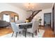 Open-concept dining area featuring hardwood floors, modern lighting, and elegant furniture at 625 Dequincy St, Indianapolis, IN 46201