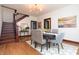 Bright dining room featuring a staircase, elegant furnishings, and stylish decor at 625 Dequincy St, Indianapolis, IN 46201