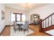 Dining room with hardwood floors, modern lighting, and view into the adjacent living room at 625 Dequincy St, Indianapolis, IN 46201