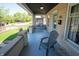 Inviting front porch with a swing and blue painted floors, perfect for relaxing outdoors at 625 Dequincy St, Indianapolis, IN 46201