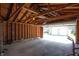 Garage with open rafters, concrete floor, and a view to the backyard at 625 Dequincy St, Indianapolis, IN 46201