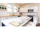 Bright kitchen with white cabinets, stainless steel appliances, and an island seating area at 625 Dequincy St, Indianapolis, IN 46201