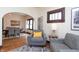 Open-concept living space featuring hardwood floors, natural light, and seamless flow into dining area at 625 Dequincy St, Indianapolis, IN 46201