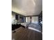 This bedroom features two cozy beds, wood flooring, and ample natural light from the windows at 6432 Commons Dr, Indianapolis, IN 46254