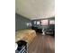 Spacious bedroom with warm lighting, hardwood floors and comfortable furniture at 6432 Commons Dr, Indianapolis, IN 46254
