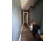 Hallway with brown hardwood floors and gray walls at 6432 Commons Dr, Indianapolis, IN 46254