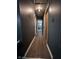 Long hallway with neutral walls and flooring leading to other rooms in the home at 6432 Commons Dr, Indianapolis, IN 46254