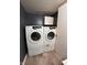 Laundry room with white Samsung washer and dryer units, offering modern convenience at 6432 Commons Dr, Indianapolis, IN 46254