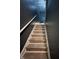 Interior staircase with tile steps and a white handrail leading up at 6432 Commons Dr, Indianapolis, IN 46254