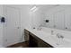 Bright bathroom with a double sink vanity and a large mirror, adjacent to a door at 6903 Aster Dr, Pendleton, IN 46064