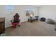 Bright bedroom with neutral walls, carpet flooring, and a gaming setup near a window at 6903 Aster Dr, Pendleton, IN 46064