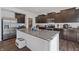 Modern kitchen with dark cabinets, stainless steel appliances, granite countertops and a large center island with a sink at 6903 Aster Dr, Pendleton, IN 46064