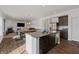 Bright, open floorplan showcasing the kitchen island that connects the kitchen to the living area at 6903 Aster Dr, Pendleton, IN 46064