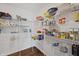 Well-organized pantry with metal shelving, fully stocked with various food items and household essentials at 6903 Aster Dr, Pendleton, IN 46064