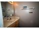 Half bathroom with modern mirror and light wood vanity with sink at 6913 Thousand Oaks Ln, Indianapolis, IN 46214