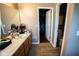 Bathroom featuring a single vanity, tile floors, and a doorway leading to a walk-in closet at 6913 Thousand Oaks Ln, Indianapolis, IN 46214