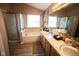 Bright bathroom featuring a soaking tub, separate shower, and a spacious vanity with marble countertops at 6913 Thousand Oaks Ln, Indianapolis, IN 46214