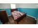 Bedroom featuring wood laminate flooring and a two-tone paint scheme at 6913 Thousand Oaks Ln, Indianapolis, IN 46214