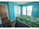 Well-lit bedroom featuring a bed, window, closet, and laminate floors at 6913 Thousand Oaks Ln, Indianapolis, IN 46214
