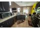 Spacious kitchen with granite countertops, stainless steel appliances, tile floors, and eat in dining area at 6913 Thousand Oaks Ln, Indianapolis, IN 46214