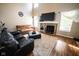 Cozy living room with a fireplace, comfortable sofas, and a large screen television at 6913 Thousand Oaks Ln, Indianapolis, IN 46214