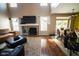 Spacious living room featuring a fireplace, TV, sofas, and open access to the kitchen at 6913 Thousand Oaks Ln, Indianapolis, IN 46214