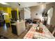 Open-concept living room with bright yellow kitchen and dining area with fireplace at 6913 Thousand Oaks Ln, Indianapolis, IN 46214