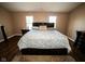 Well-lit bedroom showcasing a large bed, hardwood floors, and matching furniture set at 6913 Thousand Oaks Ln, Indianapolis, IN 46214
