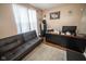 Bright home office features a comfortable sofa, a desk, a filing cabinet, and hardwood flooring at 6913 Thousand Oaks Ln, Indianapolis, IN 46214
