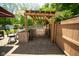 Outdoor kitchen with grill, bar, and stone surround for backyard entertaining at 6913 Thousand Oaks Ln, Indianapolis, IN 46214