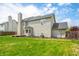 A well-manicured backyard showcases a multi-story home with a deck, blending indoor and outdoor living at 7023 Hartington Pl, Indianapolis, IN 46259