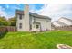 The home features a large, grassy backyard and fire pit, offering a perfect outdoor living space for relaxing or entertaining at 7023 Hartington Pl, Indianapolis, IN 46259