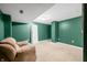 A finished basement offers a cozy lounge area with a plush couch, ready for relaxation and entertainment at 7023 Hartington Pl, Indianapolis, IN 46259