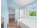 Bathroom featuring a window, soaking tub, and a separate glass door shower at 7023 Hartington Pl, Indianapolis, IN 46259