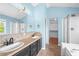 Bathroom with double sink vanity, a walk-in shower, and a soaking tub at 7023 Hartington Pl, Indianapolis, IN 46259