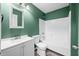 Bathroom with a white sink, toilet, and a shower and bathtub combo with white tile surround at 7023 Hartington Pl, Indianapolis, IN 46259