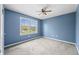 Bright bedroom featuring carpet and a large window for ample natural light at 7023 Hartington Pl, Indianapolis, IN 46259