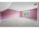 Spacious carpeted bedroom featuring a window and light pink walls at 7023 Hartington Pl, Indianapolis, IN 46259