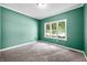 A serene bedroom with neutral carpet and a large window for ample natural light at 7023 Hartington Pl, Indianapolis, IN 46259