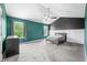 Bedroom with tray ceiling, ceiling fan, two windows, and gray carpet at 7023 Hartington Pl, Indianapolis, IN 46259