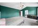 Spacious bedroom with tray ceiling, ceiling fan, and views to the ensuite at 7023 Hartington Pl, Indianapolis, IN 46259