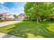 Inviting home with a lush green lawn, mature tree, and a spacious driveway leading to a three-car garage at 7023 Hartington Pl, Indianapolis, IN 46259