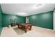 A billiards table anchors a spacious game room, offering a recreational haven inside this inviting home at 7023 Hartington Pl, Indianapolis, IN 46259