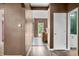 Hallway featuring modern flooring, neutral walls, and a glimpse into various rooms at 7023 Hartington Pl, Indianapolis, IN 46259