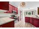 Updated kitchen features stainless steel appliances, wood cabinets and light countertops at 7023 Hartington Pl, Indianapolis, IN 46259