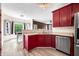 Charming kitchen boasts stainless steel appliances, wood cabinets and a breakfast nook at 7023 Hartington Pl, Indianapolis, IN 46259