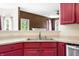 Open kitchen with stainless steel sink, light countertops and wood cabinets at 7023 Hartington Pl, Indianapolis, IN 46259