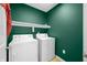 Laundry room features a washer, dryer, and a storage shelf for convenience at 7023 Hartington Pl, Indianapolis, IN 46259