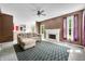 An open-concept living room with a fireplace, fan, and seamless transition to other areas at 7023 Hartington Pl, Indianapolis, IN 46259
